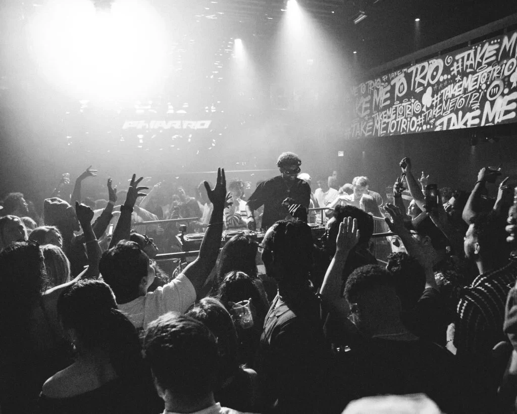 PHARRÖ performing in a crowded club, photographed in black and white